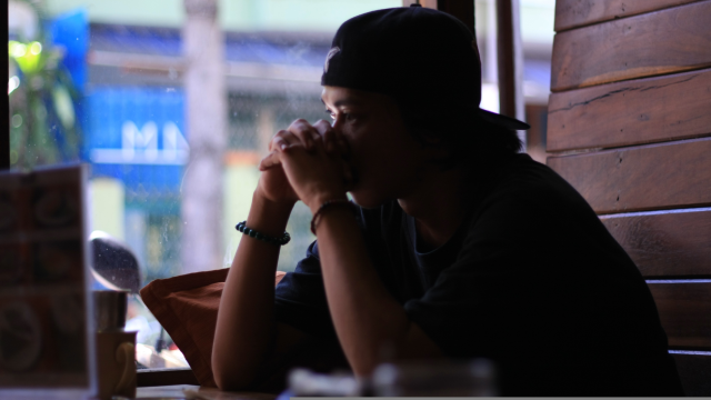 Man pensively sitting at table